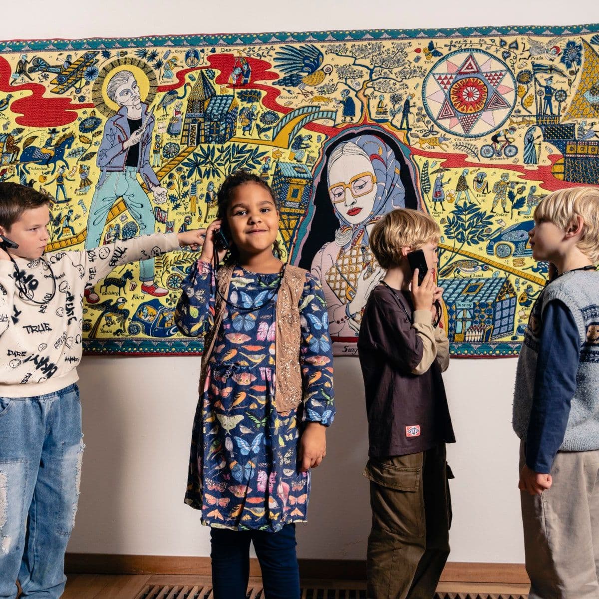 Kinderen in het museum voor een wandtapijt.