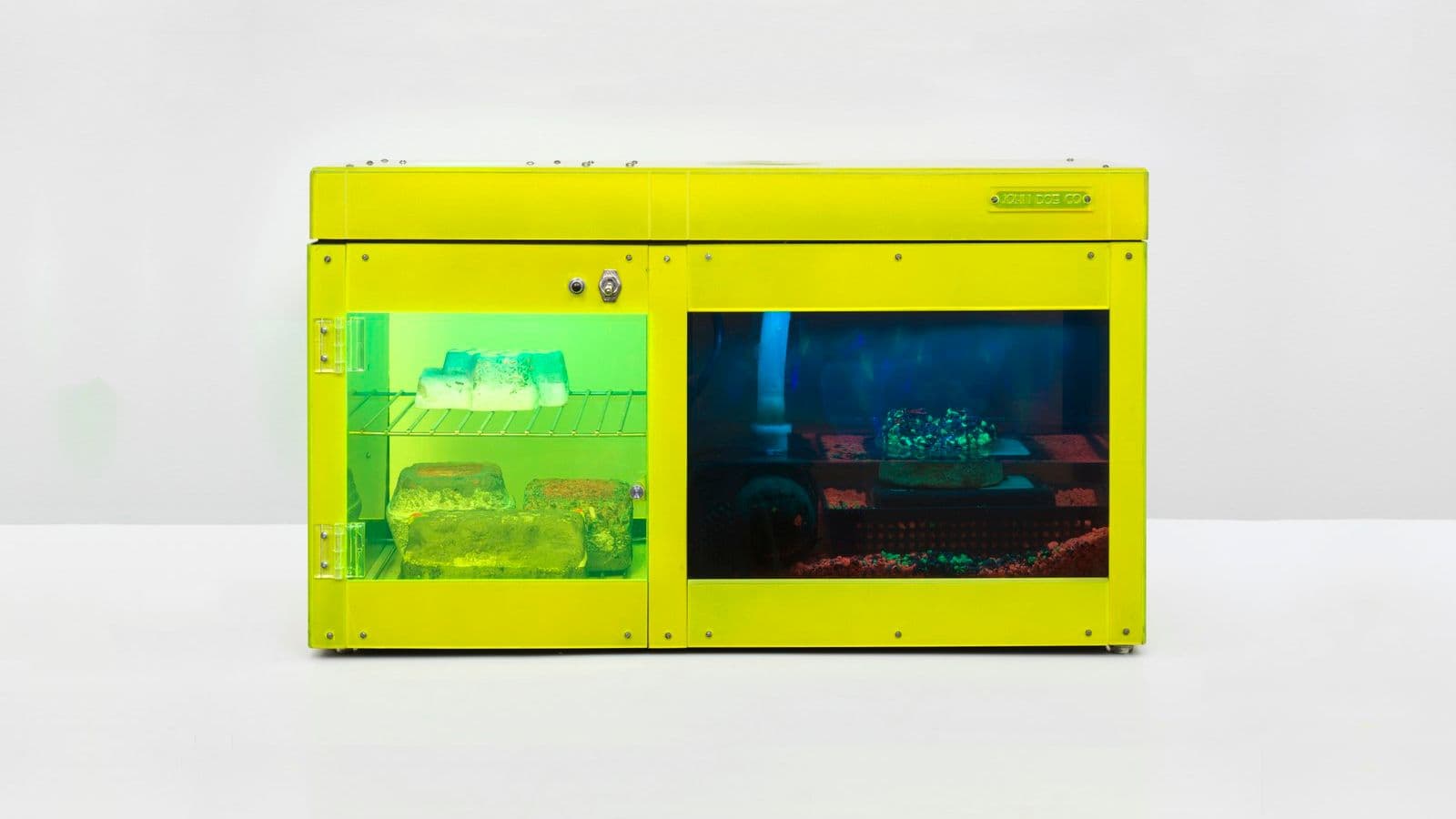 Carl Cheng, Erosion Machine No. 4, 1969-2020. Plexiglas, metal racks and fittings, plastic, water pump, LED lights, black light, pebbles, 4 erosion rocks, and wood base. Courtesy the artist and Philip Martin Gallery, Los Angeles. Photo: Jeff McLane, Los Angeles, California