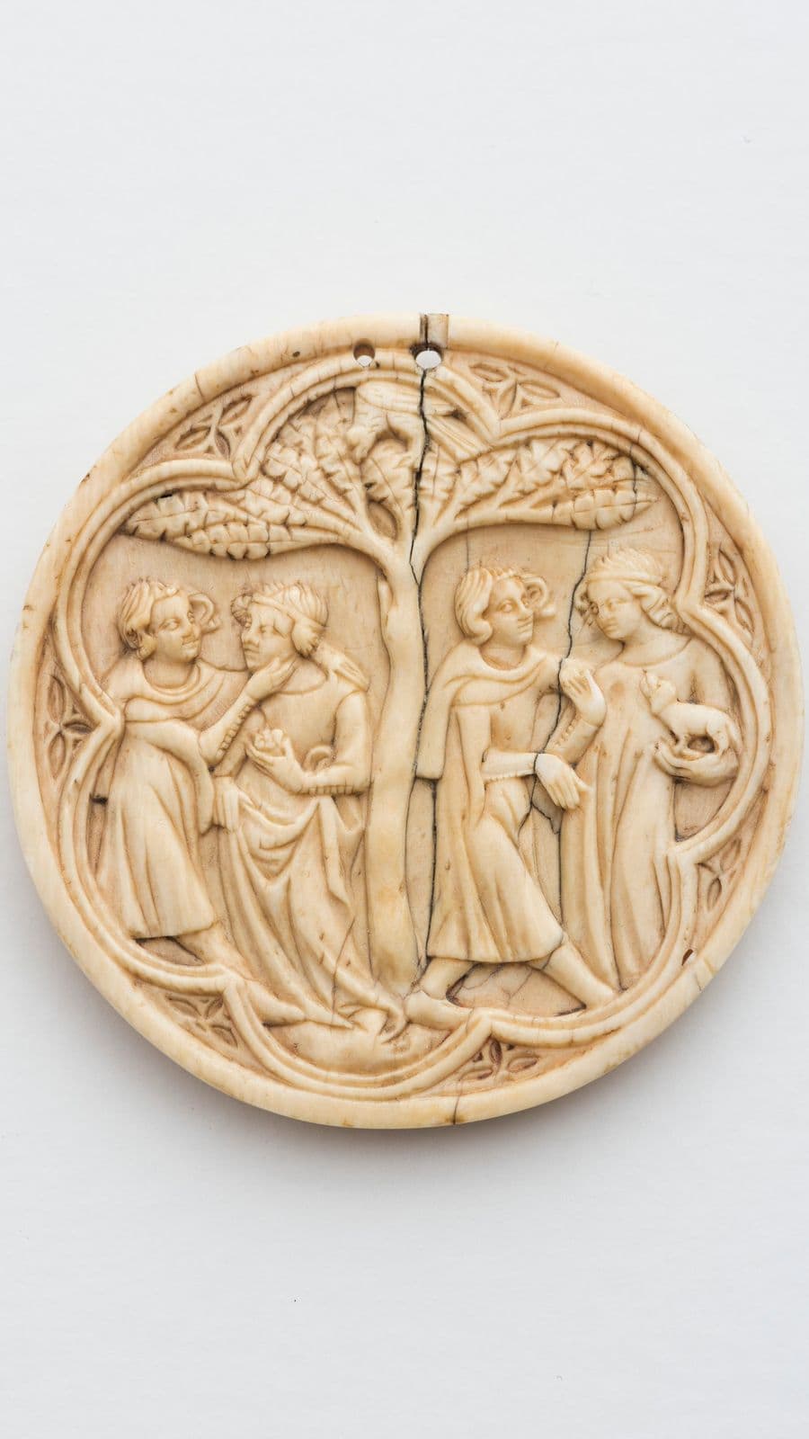 Lid of a mirror box depicting two couples in a romantic embrace